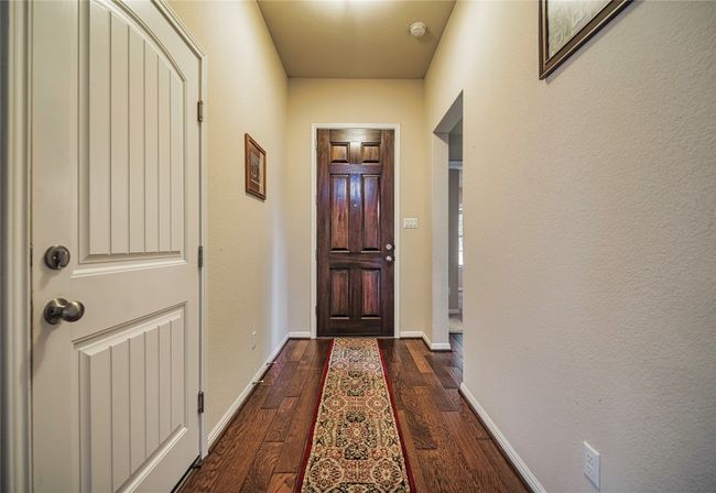 Entryway with dark wood-type flooring and baseboards | Image 7