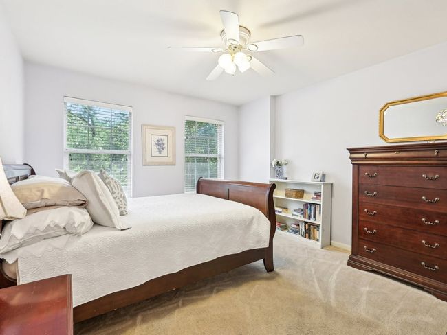 Bedroom with light carpet and a ceiling fan | Image 24