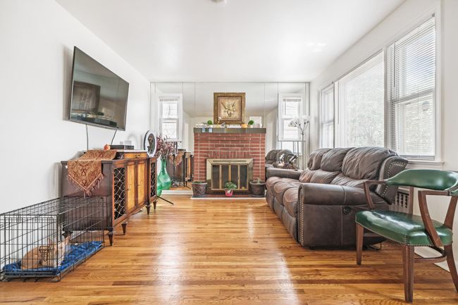 Living area featuring wood finished floors and a fireplace | Image 4