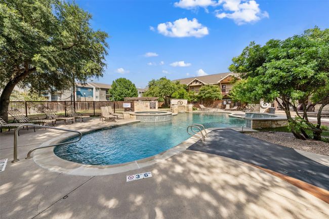 View of pool with a patio and a pool with connected hot tub | Image 22