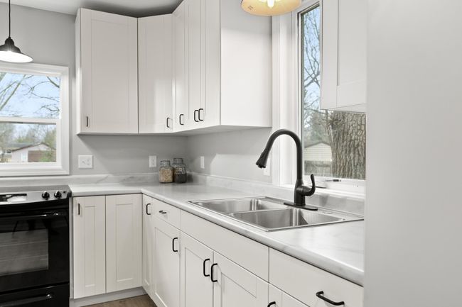 The sleek finishes in this kitchen give it a modern feel. | Image 5
