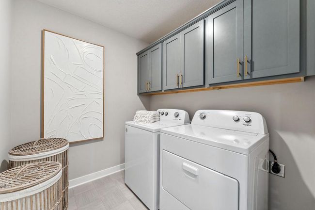 Conveniently located upstairs, your laundry room includes cabinets. Photo of model home, colors and finishes will vary. Washer and dryer not included. | Image 35