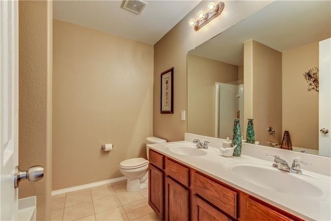 Bathroom featuring tile patterned floors, a shower, and double vanity | Image 15