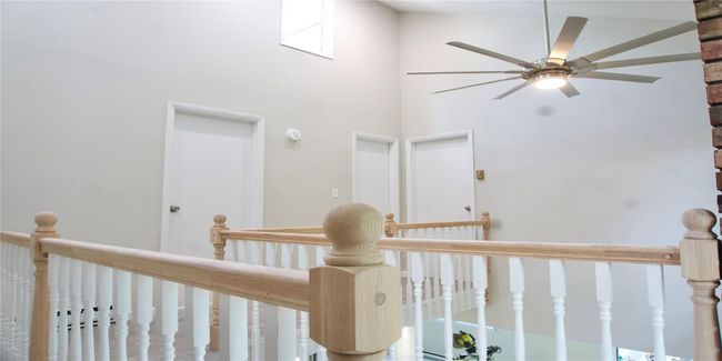 Hallway featuring an upstairs landing and a towering ceiling | Image 37