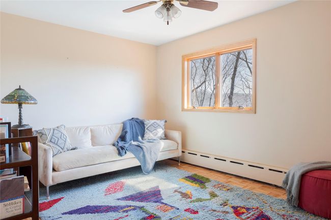 Sitting room featuring a baseboard heating unit and a ceiling fan | Image 19