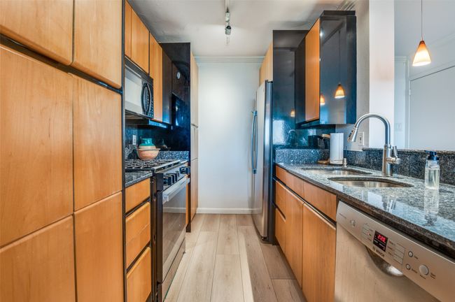 Meticulously Maintained Kitchen with Stainless Steel Appliances and Gas Range | Image 9