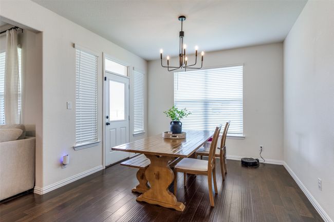Dining space with a chandelier and dark wood-style flooring | Image 11
