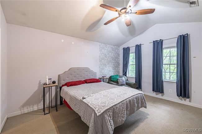 Bedroom with light carpet, vaulted ceiling, and ceiling fan | Image 17