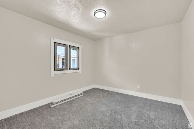 Spare room with carpet, a textured ceiling, and baseboards | Image 16