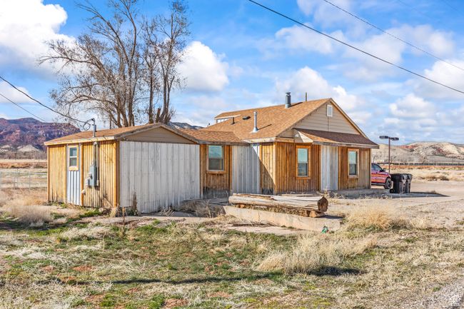 Rear view of house with a mountain view and a shingled roof | Image 26