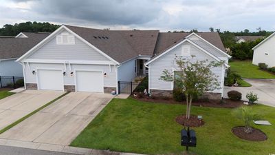 Ranch-style house with a garage and a front yard | Image 1