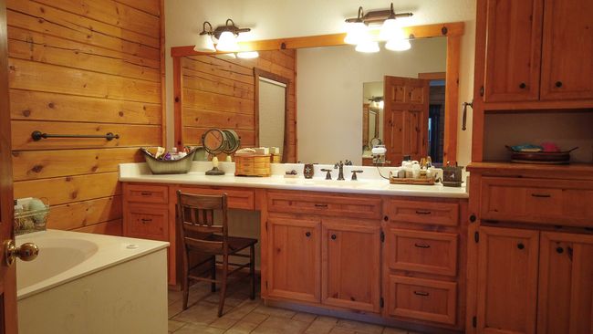 Bathroom with wood walls, vanity, and a garden tub | Image 16
