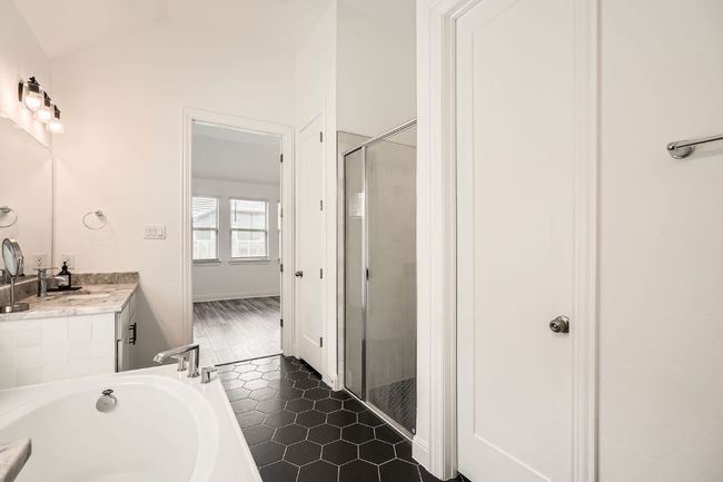Bathroom featuring a stall shower, a garden tub, vanity, and tile patterned floors | Image 19