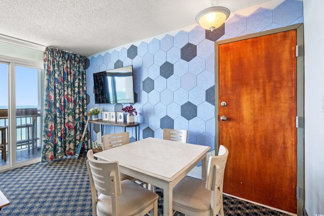 Dining room featuring carpet floors and a textured ceiling | Image 18
