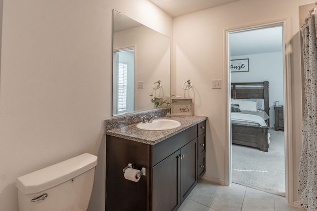 Bathroom with tile patterned floors, vanity, and toilet | Image 7