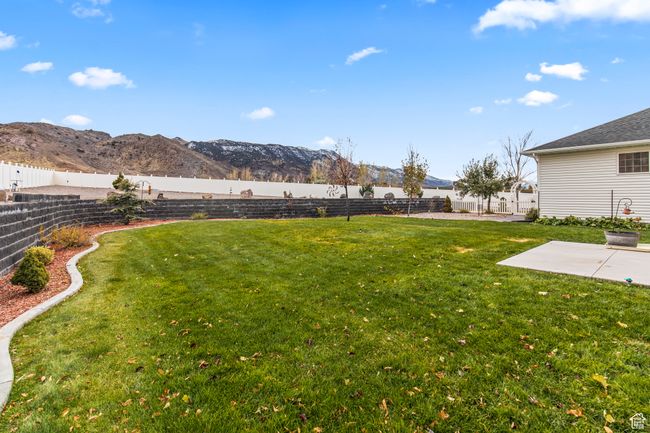 View of yard with a mountain view and a patio area | Image 11