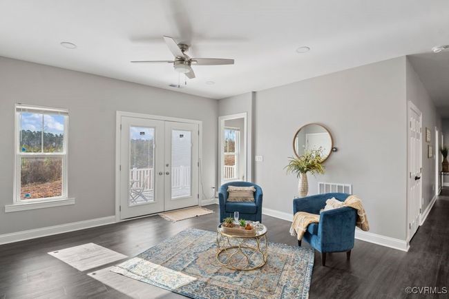 Sitting room with tons of natural lighting that leads to rear deck. | Image 9