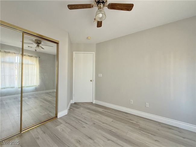 Unfurnished bedroom featuring a closet, ceiling fan, light wood-type flooring, and baseboards | Image 37