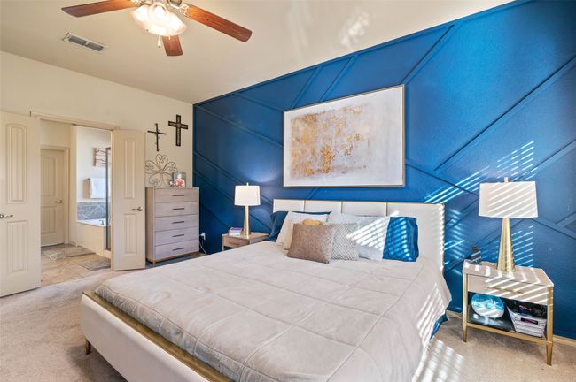 Carpeted bedroom featuring visible vents and a ceiling fan | Image 10