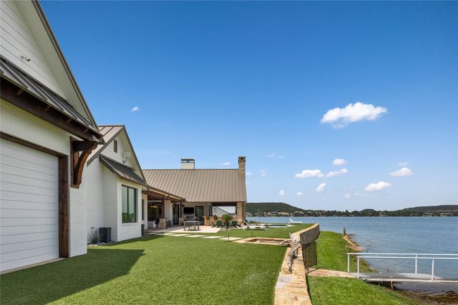 View of pool with a dock, a water view, and a lawn | Image 29
