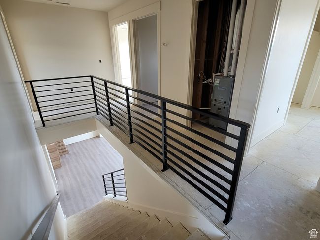 The Staircase features a wrap-around iron railing. | Image 6