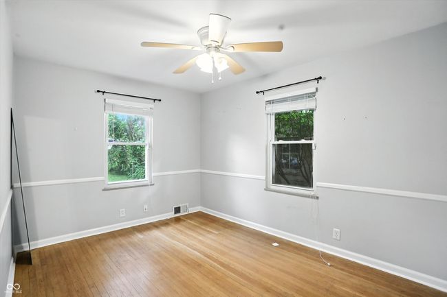 unfurnished room with wood-type flooring and ceiling fan | Image 29