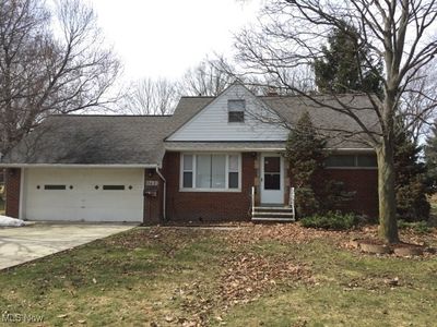 View of front of home featuring a garage and a front yard | Image 1