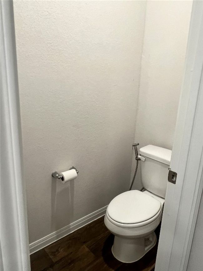 Bathroom with wood finished floors, toilet, and baseboards | Image 15