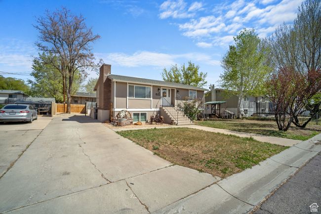 View of front of home with driveway, fence, and a chimney | Image 25