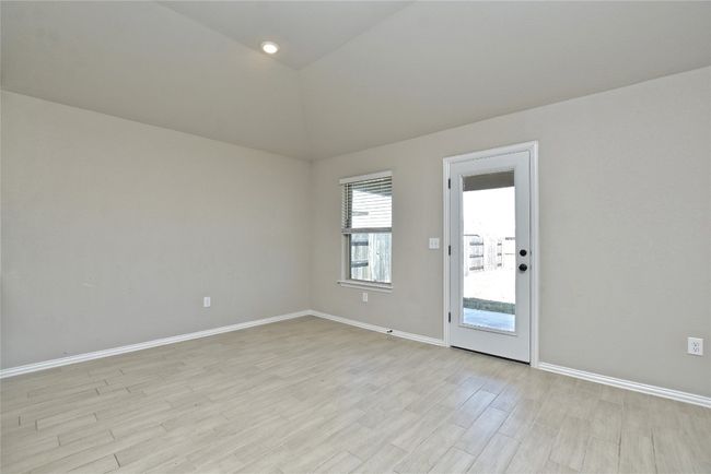 Spare room with light wood-type flooring, lofted ceiling, and baseboards | Image 13