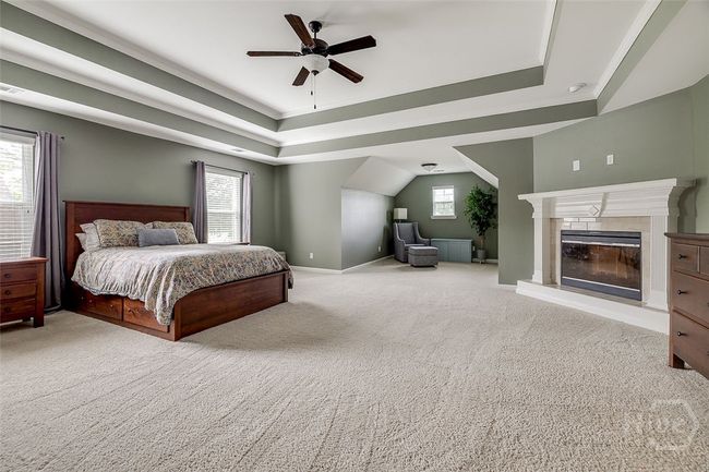 Master bedroom has a fireplace and sitting area. | Image 26