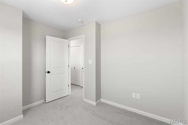 Unfurnished bedroom with baseboards and light carpet | Image 19