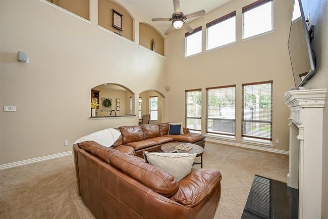 A wall of tall windows allows abundant natural light to pour in, creating a bright and airy atmosphere. | Image 26