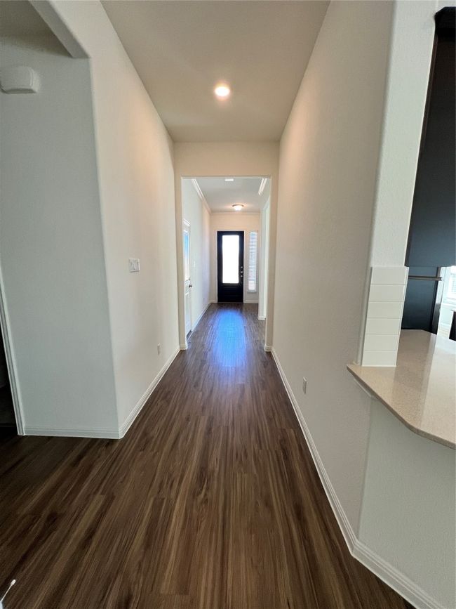 Hallway featuring dark wood-style floors and baseboards | Image 19