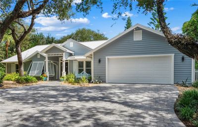 Live the Florida lifestyle in Indian River Shores (32963) at 101 Chiefs Trail located in Indian Trails. This 4/3 coastal designed and inspired home is tucked inside a sprawling oak canopy in Indian Trails -- one of Vero Beach's premier ocean to river developments | Image 1