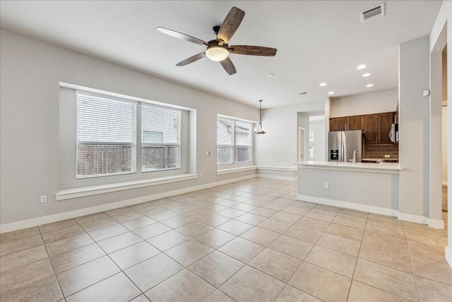 Unfurnished living room with recessed lighting, light tile patterned flooring, ceiling fan, and baseboards | Image 8