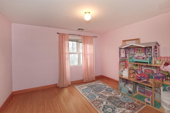 Game room featuring baseboards, visible vents, and wood finished floors | Image 9
