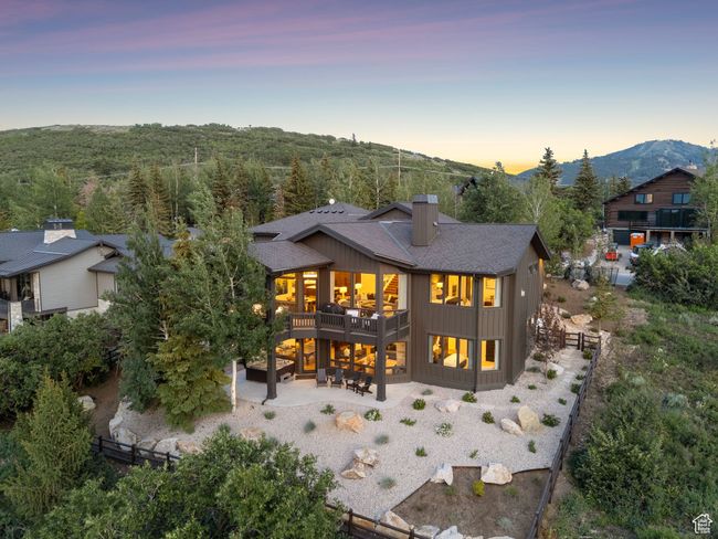 Back of house with a patio area, a chimney, a shingled roof, and a mountain view | Image 87