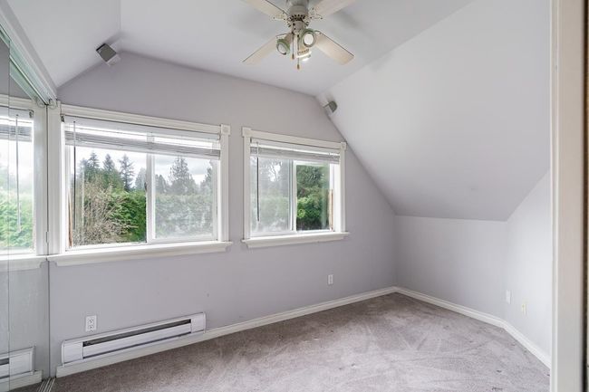 Bonus room with vaulted ceiling, a ceiling fan, a baseboard radiator, baseboards, and carpet | Image 32