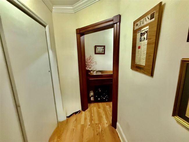 Hallway featuring ornamental molding and light wood-style floors | Image 11