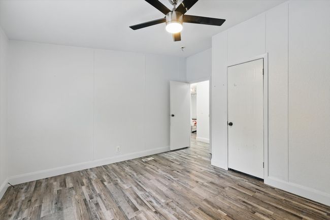 Unfurnished bedroom with baseboards, wood finished floors, and ceiling fan | Image 18