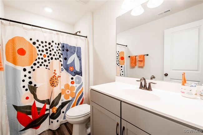Bathroom featuring vanity, wood finished floors, and curtained shower | Image 27