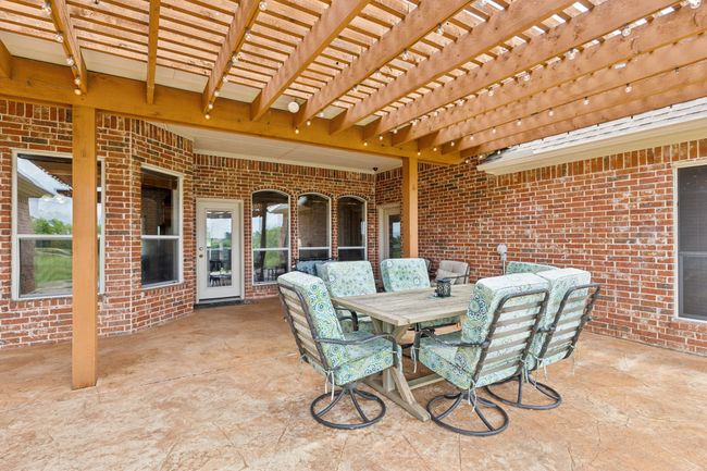 View of patio featuring a pergola and outdoor dining area | Image 33