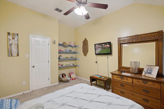 Another view of secondary bedroom with built in shelves. | Image 18