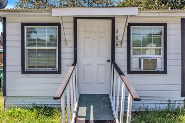 Property entrance with a metal roof | Image 24