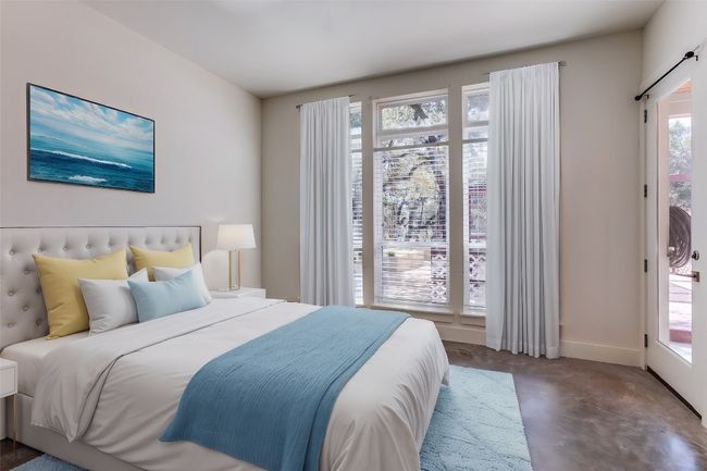 Bedroom with concrete flooring and baseboards | Image 13