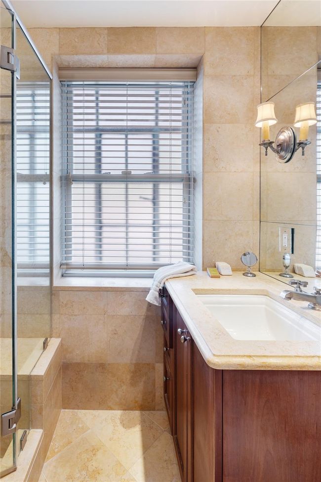 Full bath with vanity, a stall shower, tile walls, and tile patterned flooring | Image 14