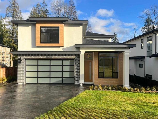 View of front facade with an attached garage, brick siding, and asphalt driveway | Image 26