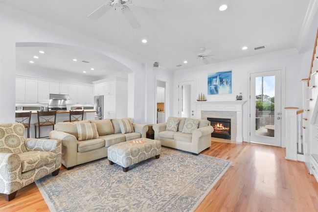 This spacious living room seamlessly connects to the kitchen, perfect for hosting gatherings. | Image 12