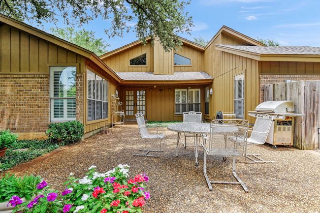 Rear view of property featuring a patio, roof with shingles, outdoor dining area, french doors, and brick siding | Image 33